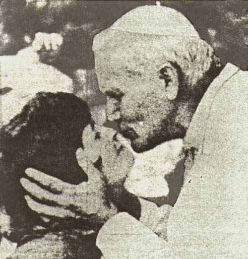 John Paul II kissing a young woman